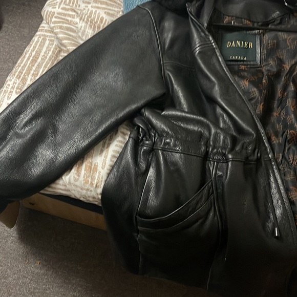 This is a huge leather jacket with fur lining at neck. - Picture 4 of 5